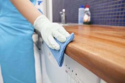 Cleaner polishing a kitchen counter in a Black Forest CO residence.
